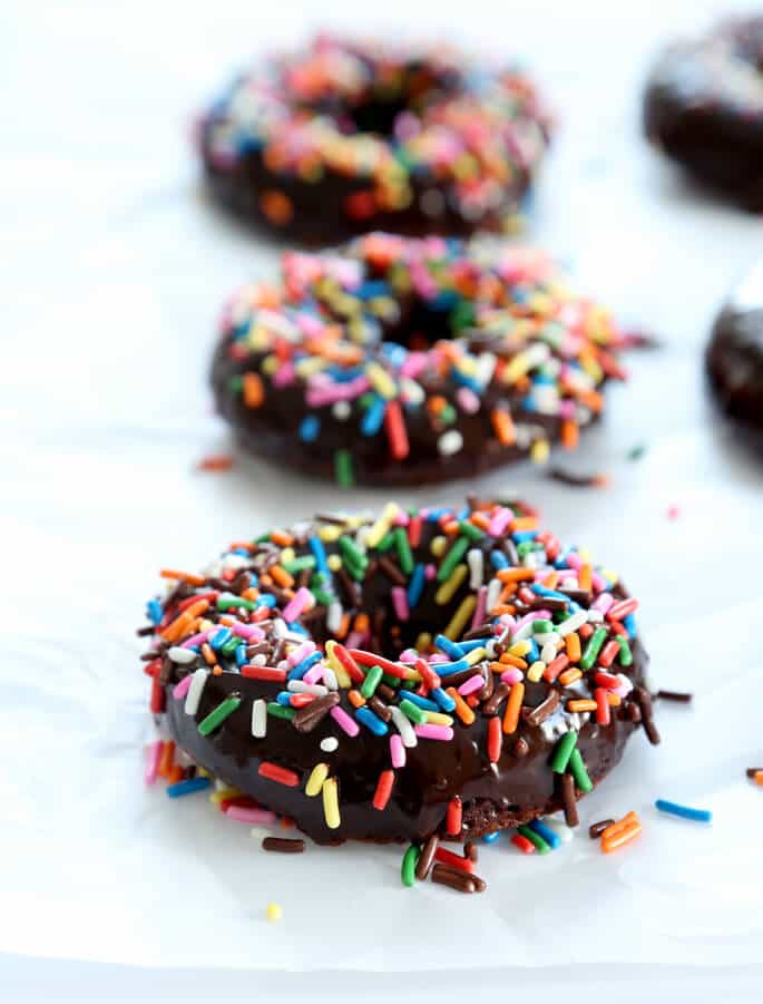 These quick and easy gluten free chocolate cake donuts are the perfect way to satisfy your donut cravings. Make them in a donut pan or a muffin tin. And don't forget the rich chocolate glaze!