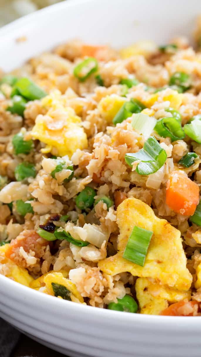 Tasty cauliflower fried rice is the low carb, Paleo recipe that satisfies your craving for takeout. Learn to make riced cauliflower the easy way with frozen, defrosted cauliflower. https://glutenfreeonashoestring.com/