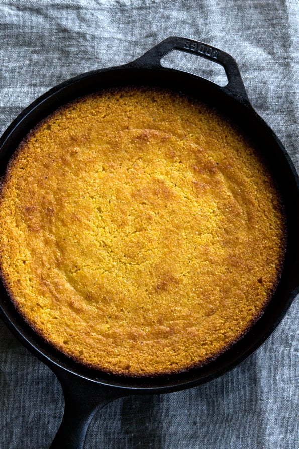 Gluten free cornbread baked in a cast iron skillet, pictured from above.