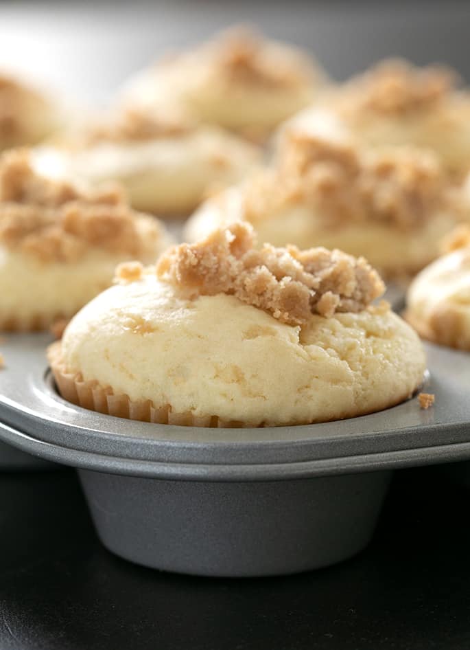 Gluten free coffee cake muffins baked in muffin tin image from the side to see crumble and texture close up.