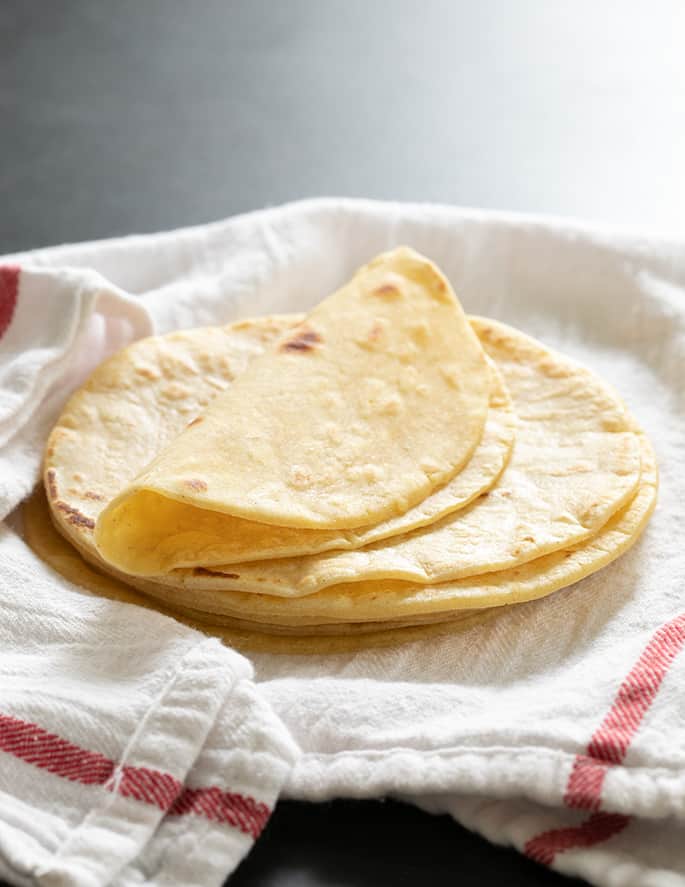 Stack of tortillas on towel 