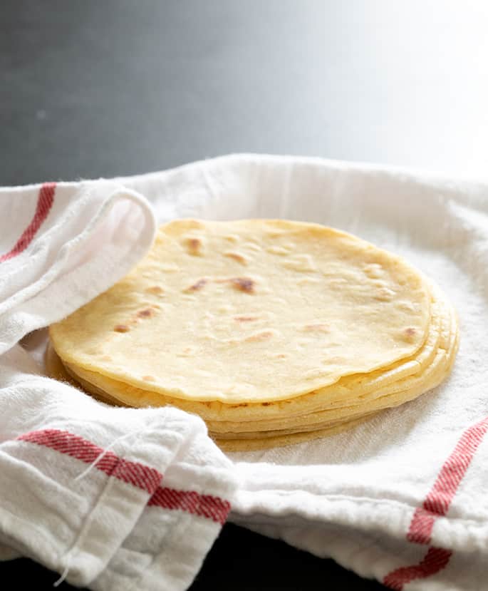 Tortillas on white and red towel 