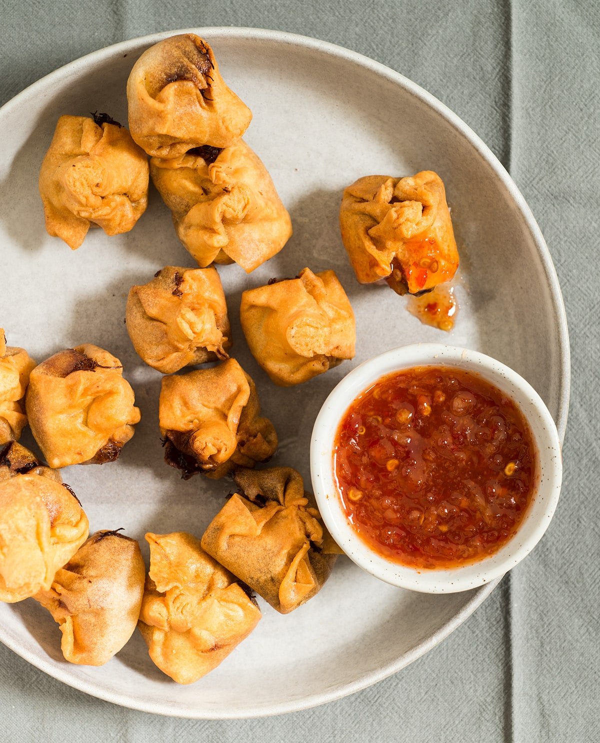 gluten free crab rangoon on plate with dipping sauce
