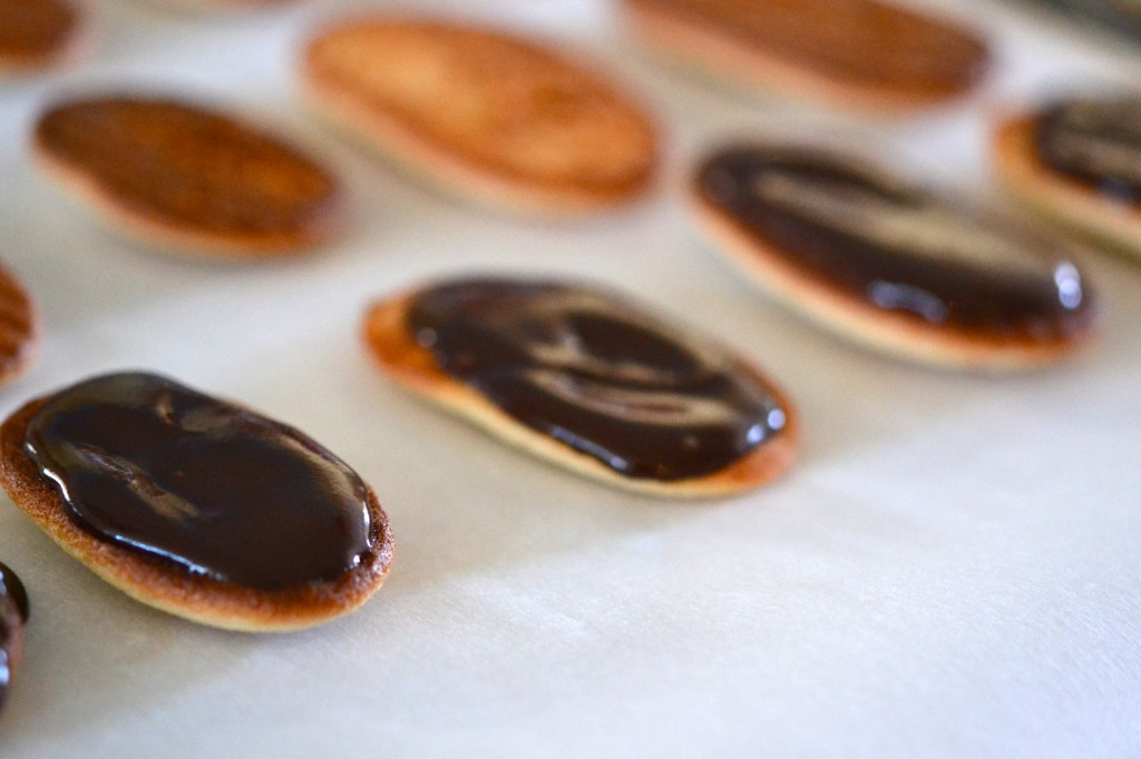 Milano Style Copycat Cookies being coated in chocolate sauce 