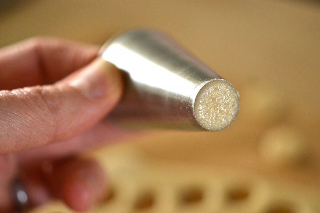 A close up of a person holding metal tool