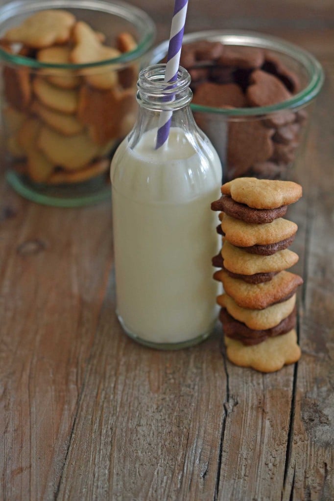 Stack of cookies and milk on wooden table 