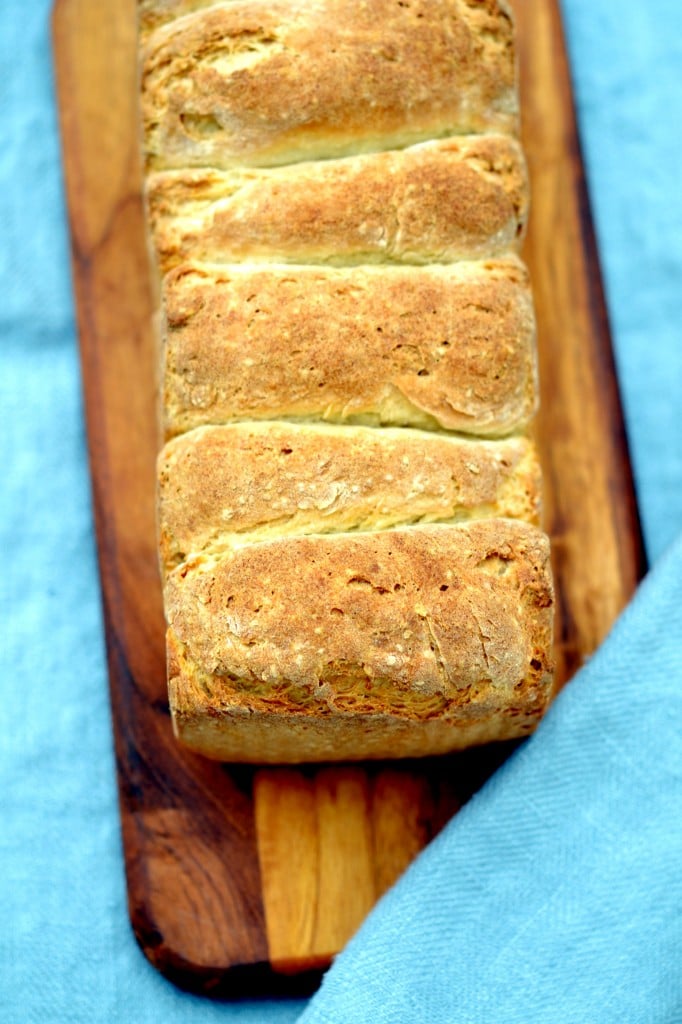 Overhead image of a loaf of bread on a wooden board