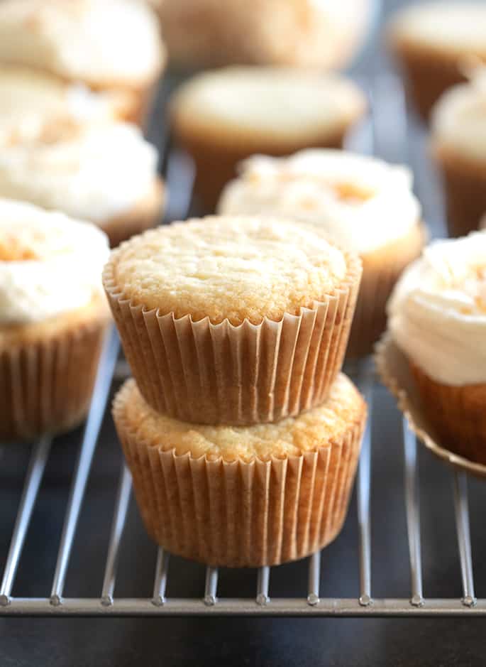 Coconut cupcakes in a stack on a wire rack