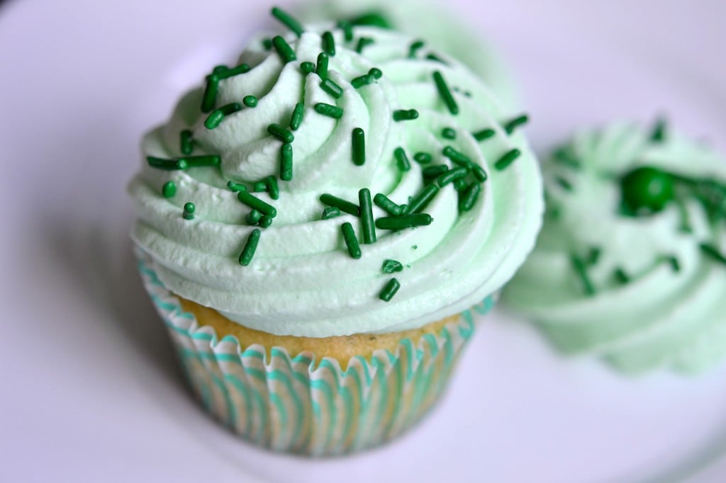 A close up of a decorated cupcake on purple surface