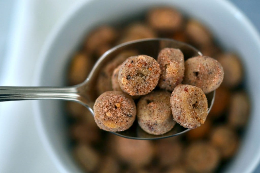 A close up of Apple jack style cereal in a spoon