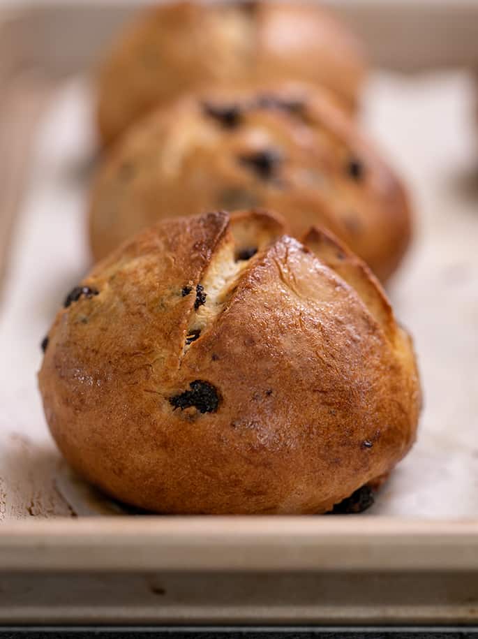 Hot cross buns baked on white paper on tray