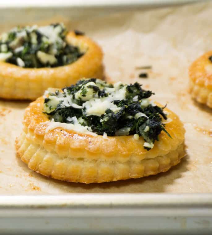 Close up view of spinach puff pastry on brown paper