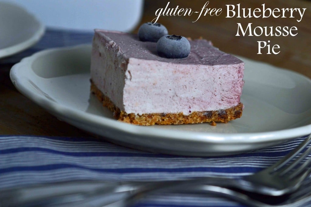 Slice of pie and blueberries on white plate 