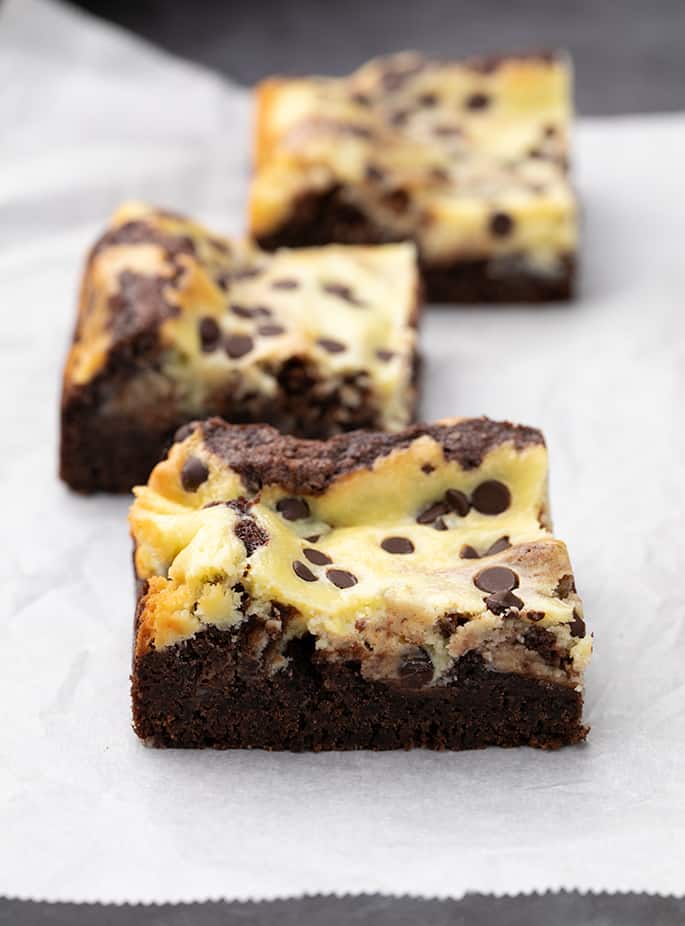 Three marble brownie squares on white paper