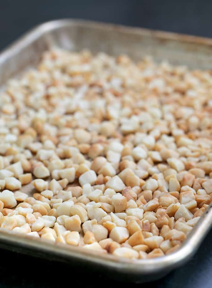 Macadamia nut pieces toasted on a tray