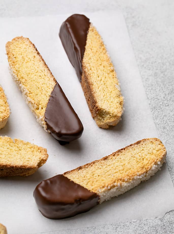 Chocolate dipped vanilla biscotti on white paper