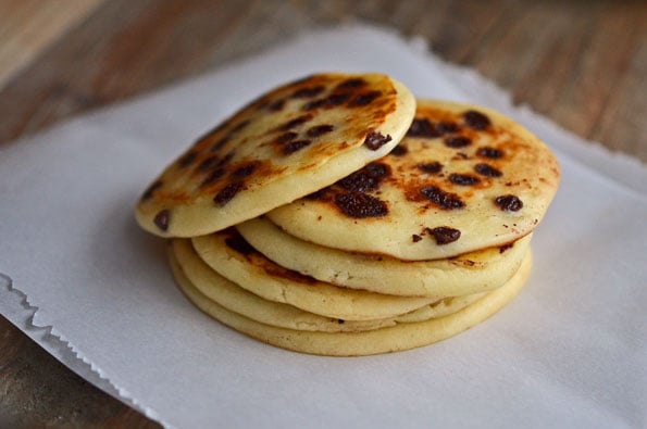 Stack of chocolate chip pancakes on white surface 