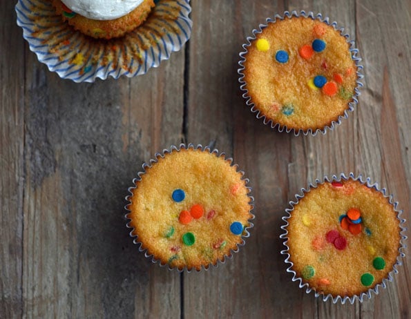 Overhead view of funfetti cupcakes on wooden surface 