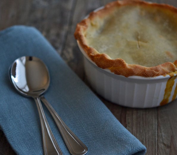 Pie in a white dish with spoon next to it