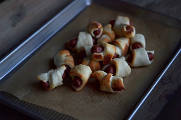 Group of pigs in a blanket on beige surface 