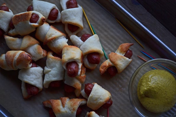 Group of pigs in a blanket on beige surface 