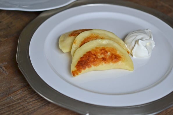 Close up of 3 pierogis on a white plate