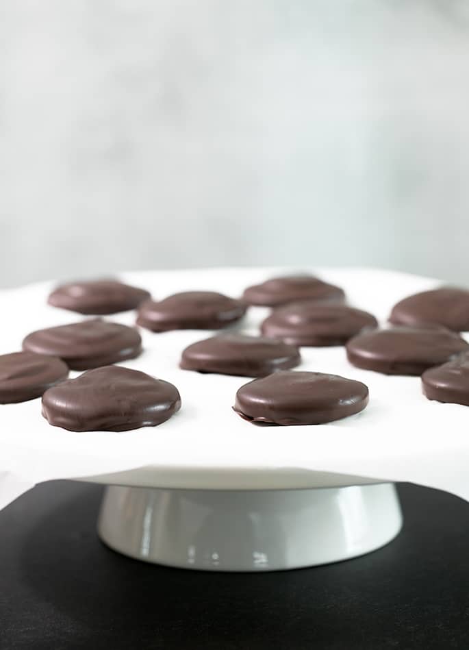 A cake plate with tagalong cookies on white paper