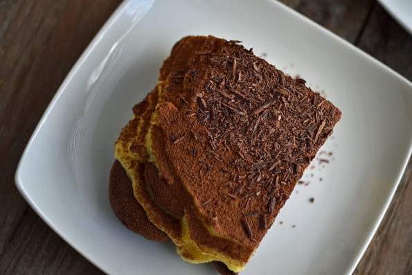 Overhead view of tiramisu on white plate