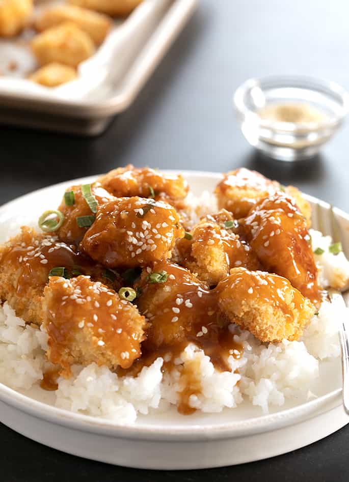 Gluten free sesame chicken being served.