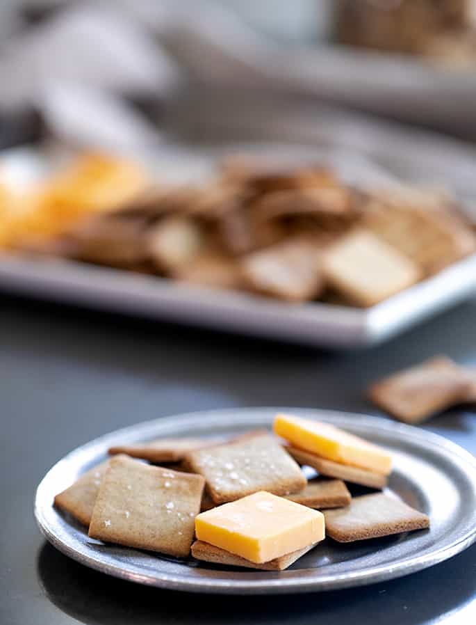 A small plate with gluten free wheat thins style crackers and cheese