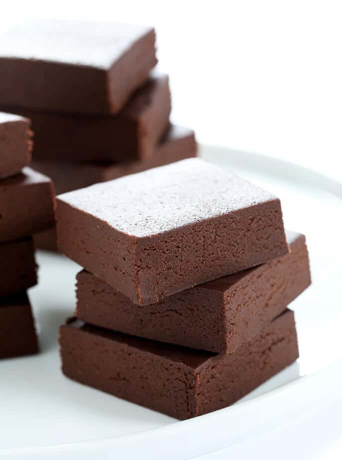 A close up of a stack of fudge on white plate