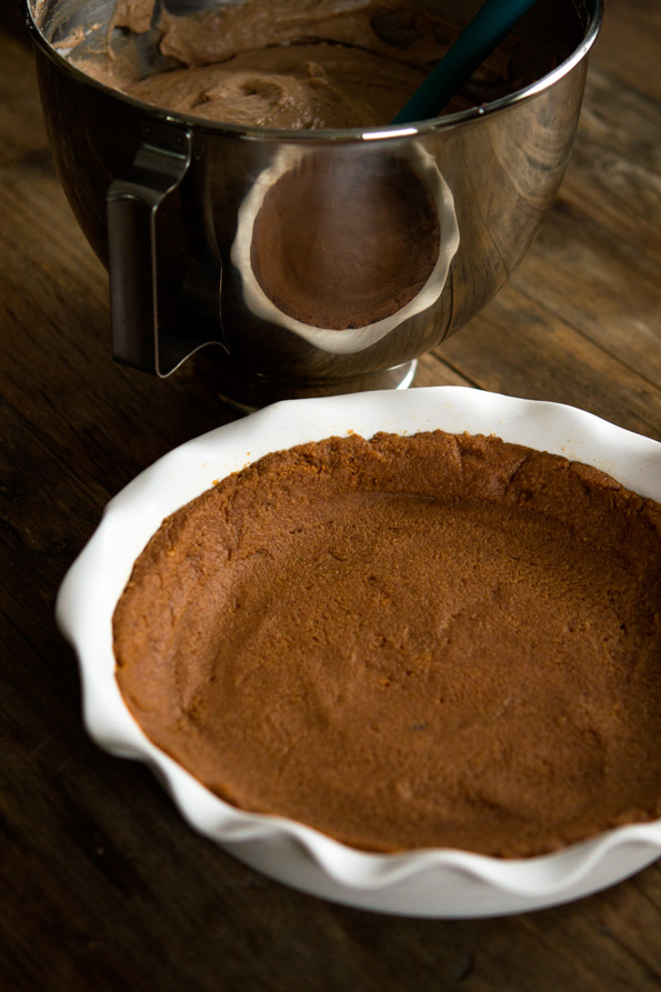 Peanut butter mousse pie crust in white pie dish