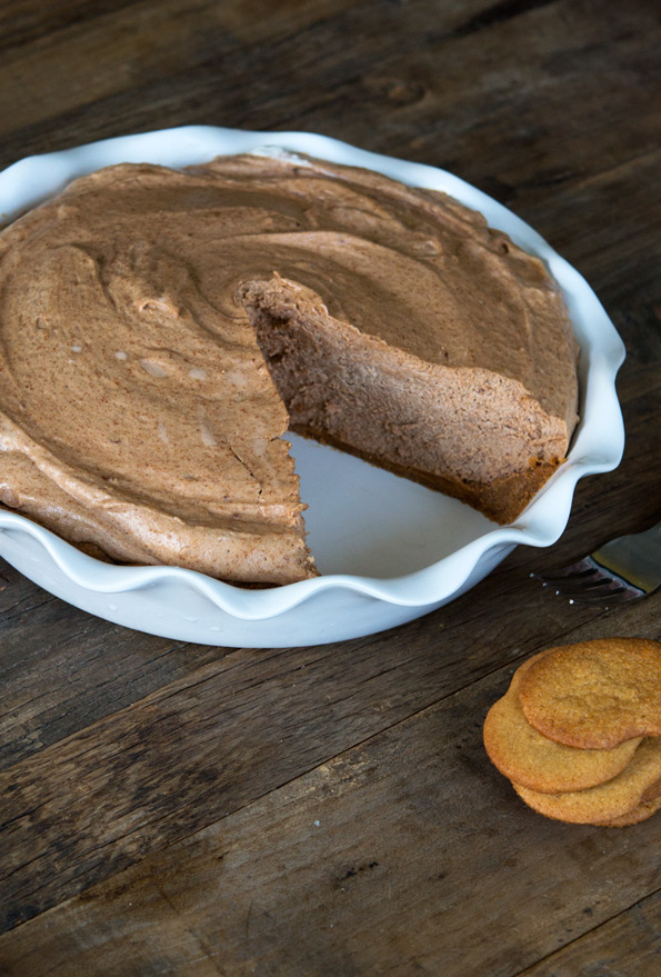 Peanut butter mousse pie with a slice missing in white pie dish