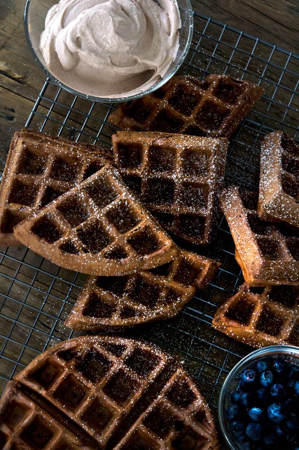 Overhead view of chocolate waffles on black tray