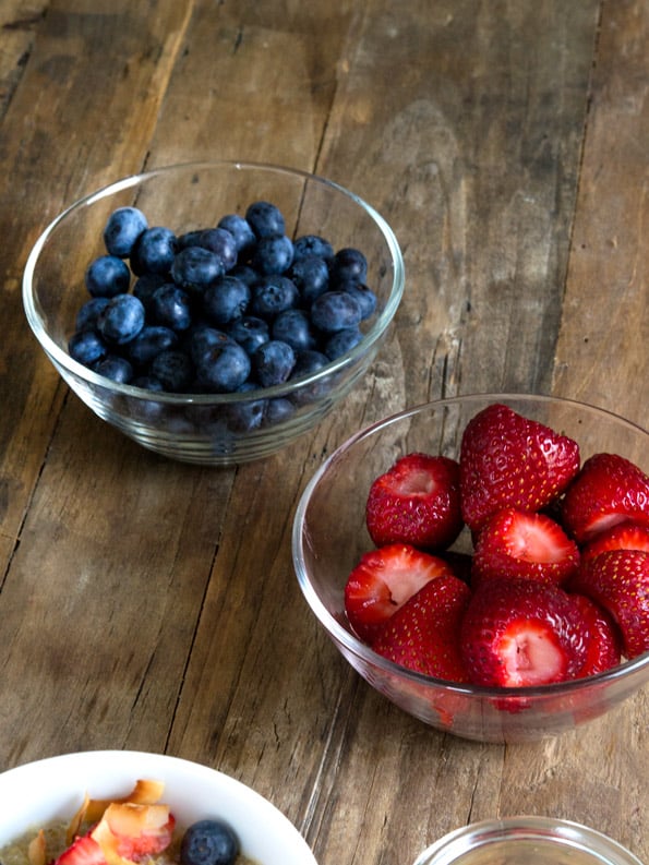 A bowl of fruit sitting on top of a wooden table