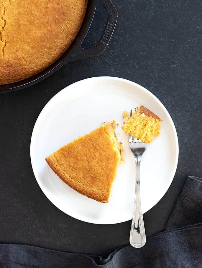 Old fashioned gluten free cornbread corn flour variation, slice on plate with forkful.