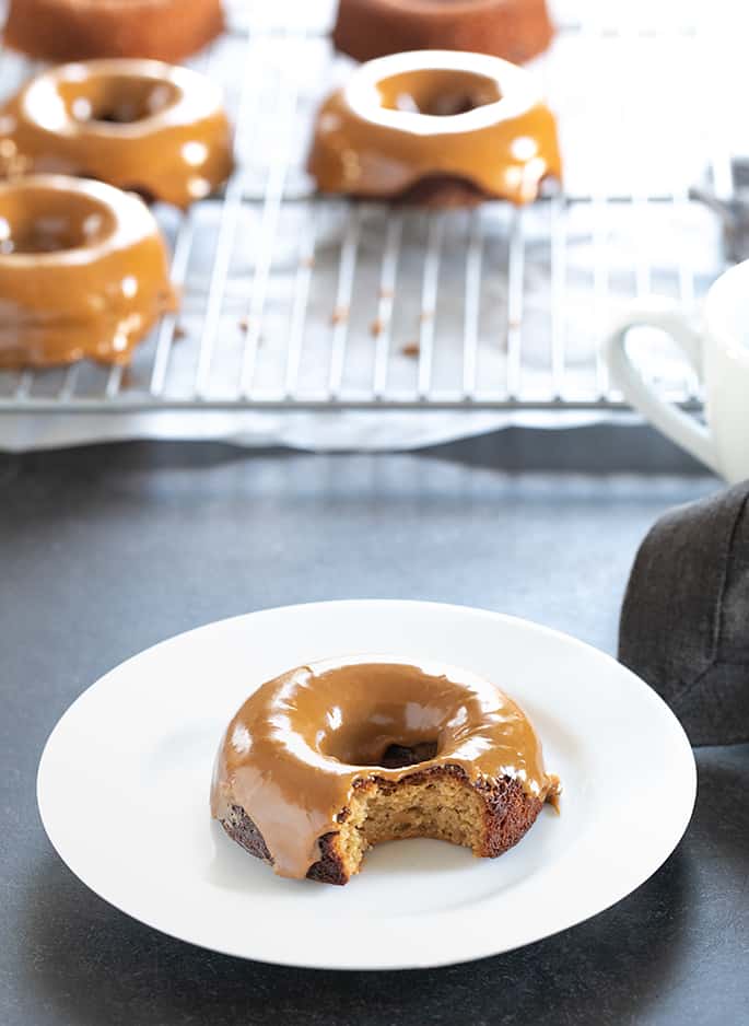 A Paleo donut on a plate with a bite taken