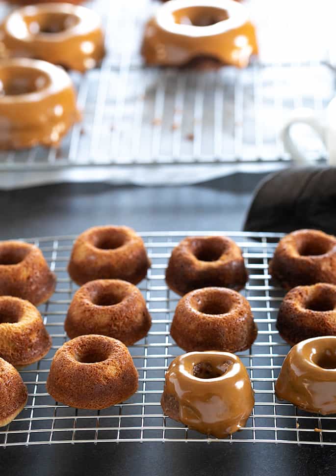 Paleo donuts on a wire rack, some with glaze