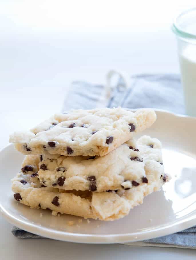 A stack of 3 pieces of cookie break up on white plate 