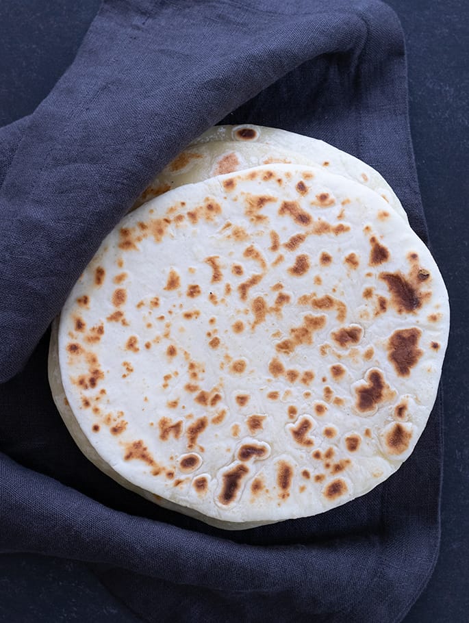 Overhead image of soft tapioca wraps in a stack with a cloth