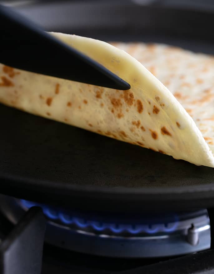 Flipping over a soft tapioca wrap with a spatula