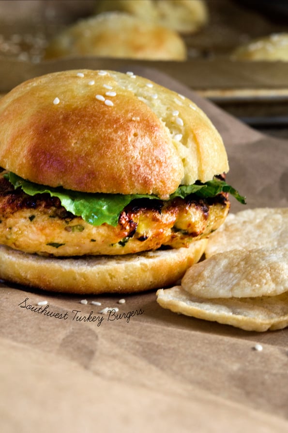 A close up of a turkey burger on brown surface