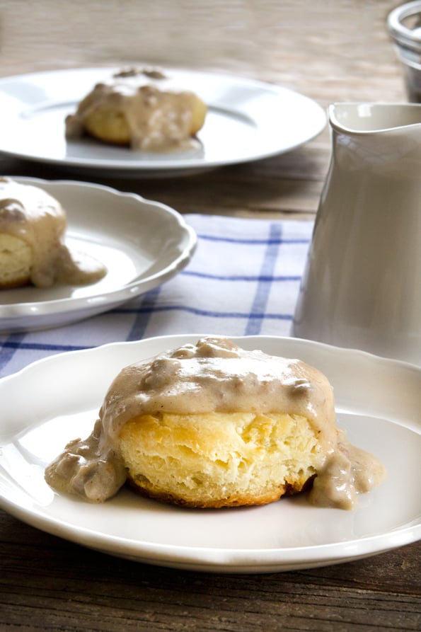 Biscuits and gravy on white plate