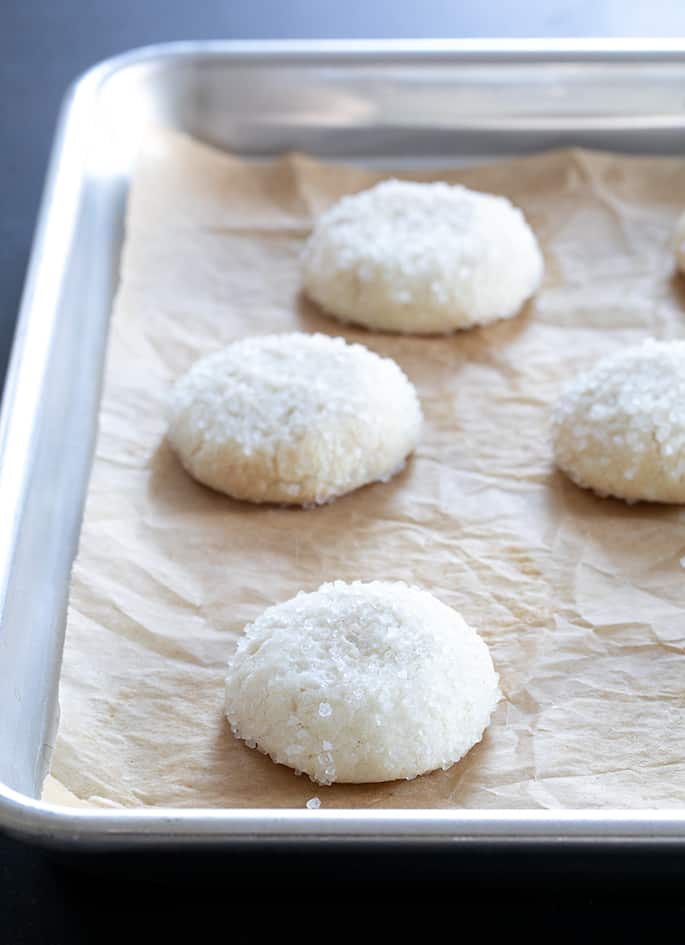 Drop sugar cookies with white sugar on a tray