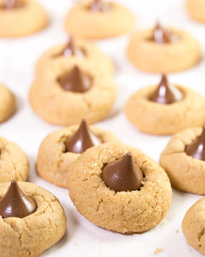 Focused image of peanut butter blossom cookies on white surface