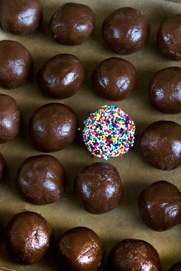 Overhead image of fudge truffles, one with nonpareils