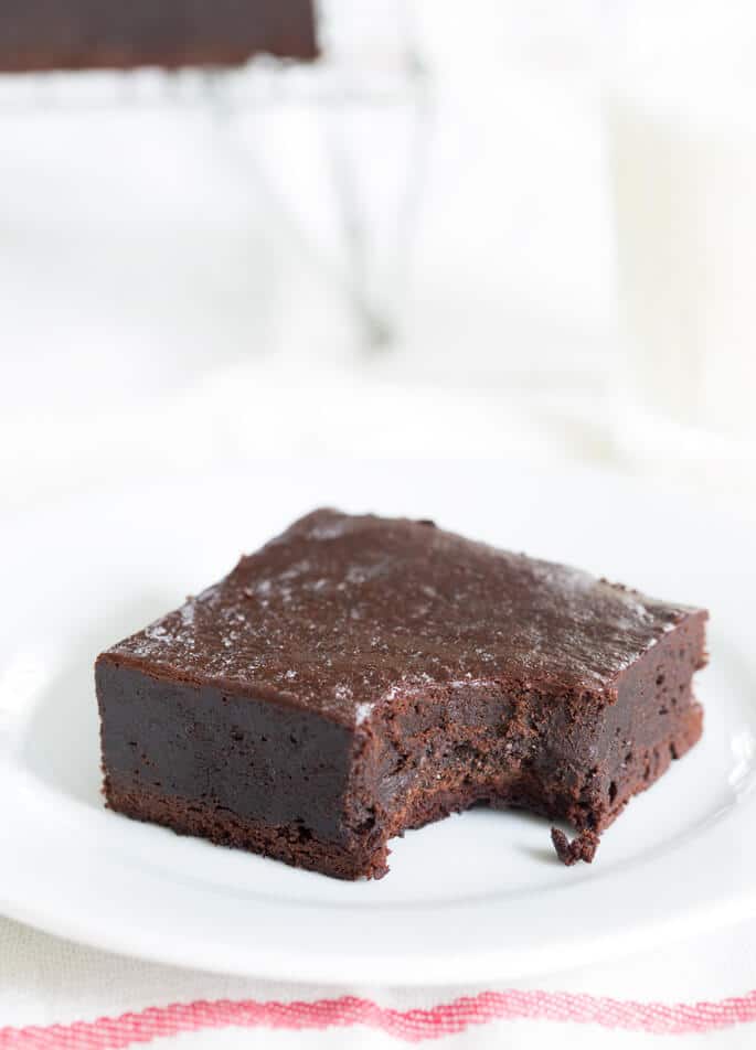 Close up view of inside a paleo brownie on white plate