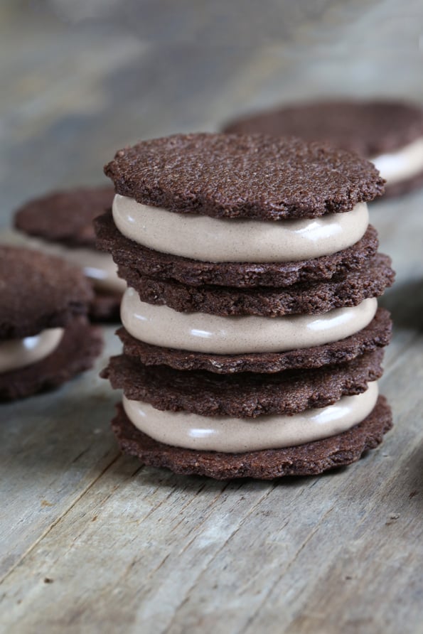 Crunchy Paleo chocolate cookies filled with Paleo 7-minute frosting to satisfy your sweet tooth, and still stay on your Paleo diet!