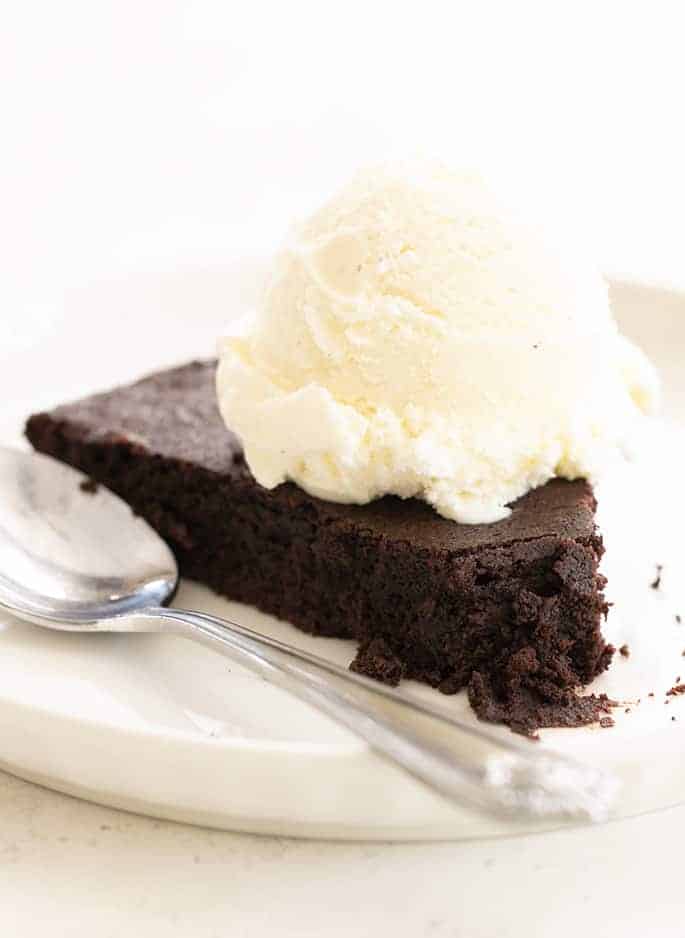 Skillet brownie on plate with ice cream and spoon