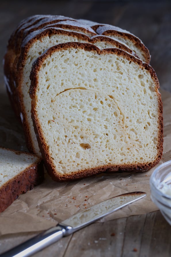 A close up of a slice of vanilla swirl bread on wooden surface